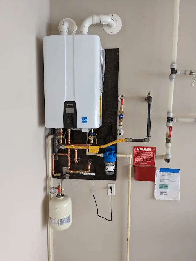 Professional plumber installing copper piping in a Ridgewood home